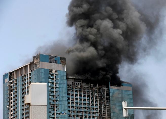 Smoke rises after a fire broke out in a building at Al Maryah Island in Abu Dhabi