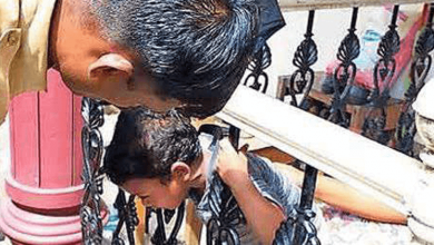 BOY'S HEAD STUCK BETWEEN BARS